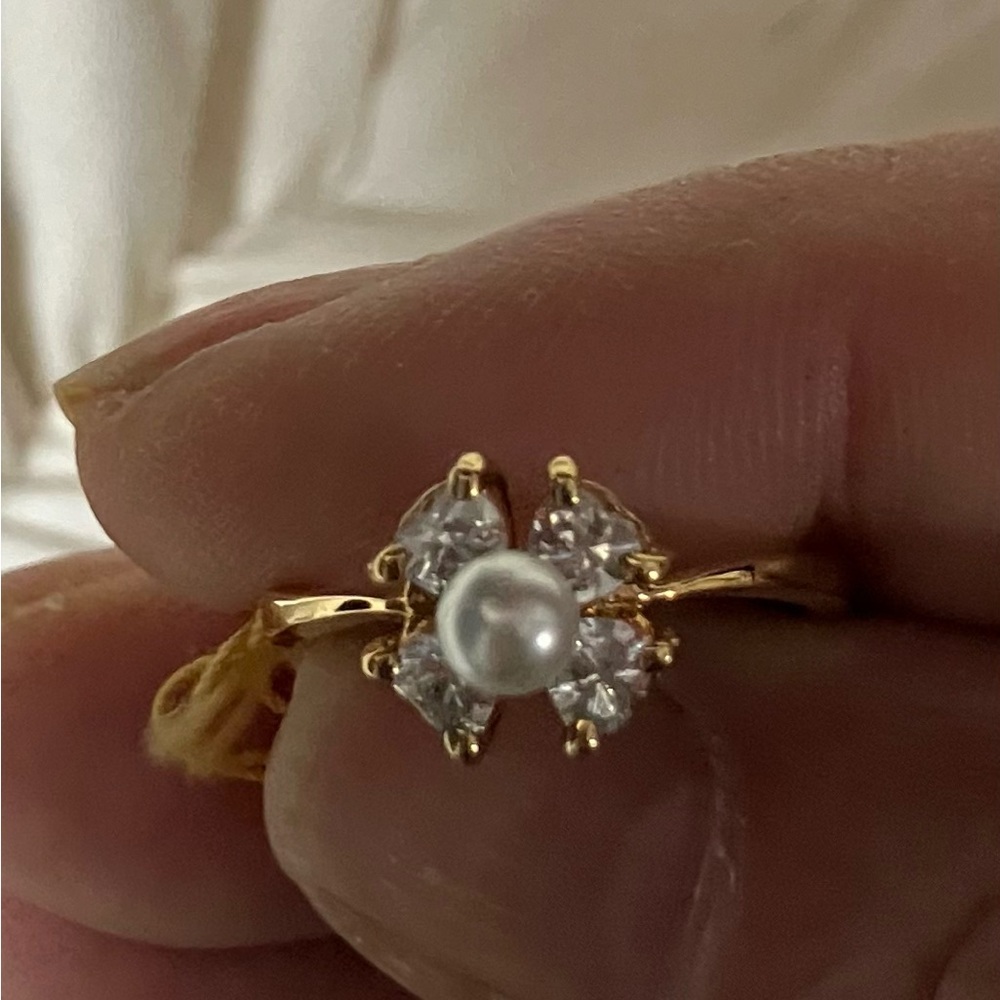A dainty pearl and Swarovski crystal ring set in gold